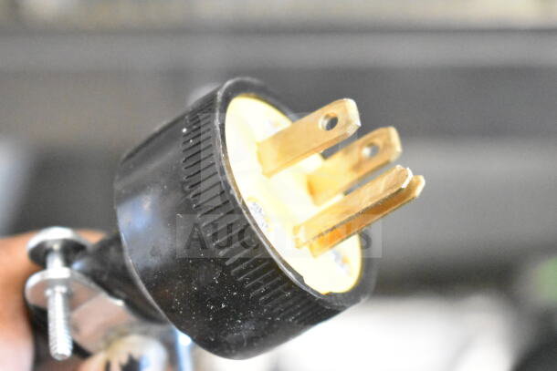 Close-up of the plug of a 2016 Bizerba GSP H Commercial Meat Slicer, 120V, 1 Phase. Black casing with visible prongs.