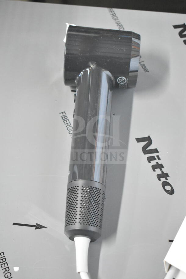 Hair dryer with reflective finish; power cord cut. Includes five other items: hair brushes and more. Condition varies.