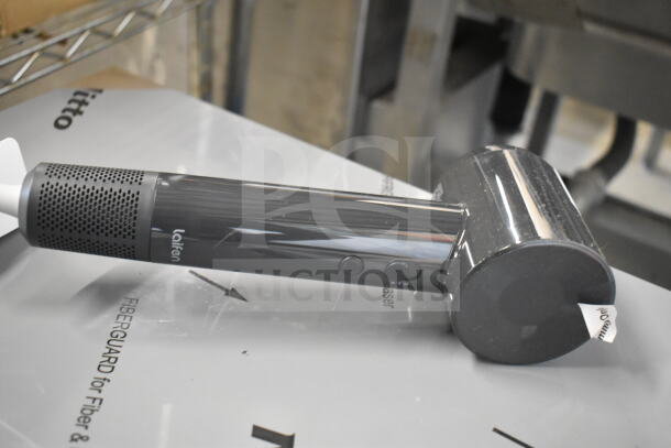 Black Lalrem hair dryer, cylindrical design, buttons on handle, missing power cord.
