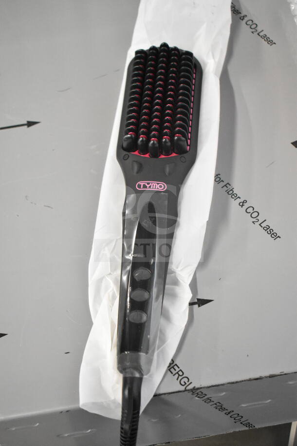 Black TYMO electric hair straightening brush with pink accents. Power cord is cut.