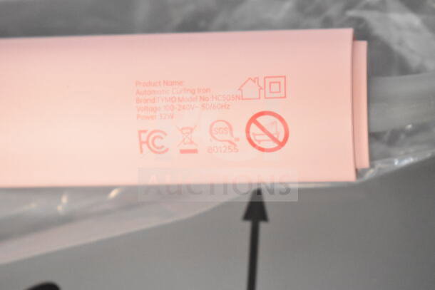 Pink automatic curling iron, brand TYMO, model HC503N, voltage 100-240V, 52W. Labels include FCC and SGS marks.