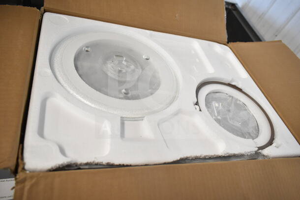 Hamilton Beach 100714402 Countertop Microwave Oven in original packaging, showing glass turntable and components securely packed.