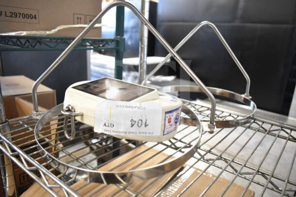 Detecto SCS30 hanging produce scale with two metal attachments, displayed on a metal shelf. Labels show item code and info.