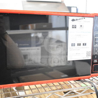 Hamilton Beach MS8436127995-02 countertop microwave oven with red trim. Model label visible. Door does not open. 120V, 1 phase.