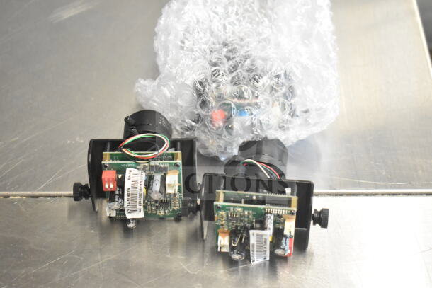 Box of Wren Cameras, showing electronic components and wiring. Items are in bubble wrap, condition appears used. Markings include model number YP1202 and "Made in Italy."