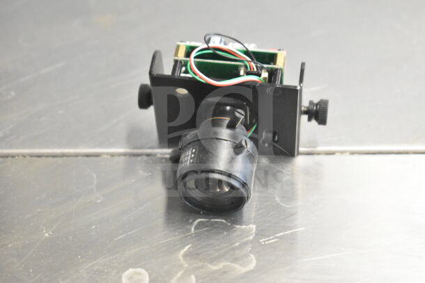 Box of Wren cameras with exposed wiring and lens, used condition, mounted on metal brackets, suitable for parts or repair.
