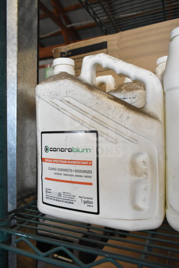 White 1-gallon Conrobium disinfectant jug with visible label. Some scratches and dust apparent, indicating storage wear.