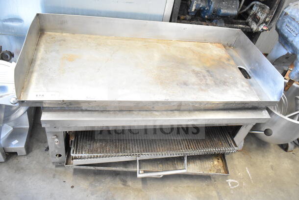 Commercial countertop flat top griddle with cheese melter, stainless steel, used condition, item tag 118 visible.