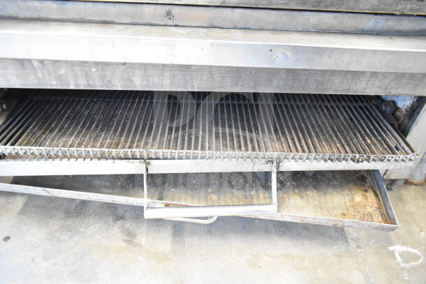 Commercial countertop flat top griddle with cheese melter, stainless steel, visible wear, includes drip tray, used condition.