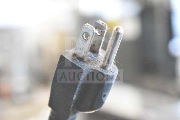 Close-up of a worn plug end of the Avantco 177W50CKR Commercial Countertop Food Warmer, indicating used condition.