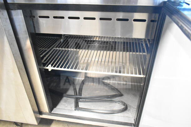 Turbo Air MST-72-30 commercial prep table interior showing metal shelving and storage space, suitable for restaurant use.