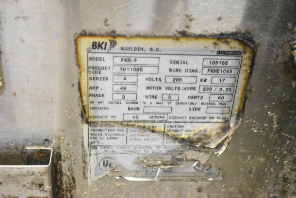 BKI FKM-F commercial pressure fryer label showing model, serial number, voltage, phase, and wiring details. Visible wear.