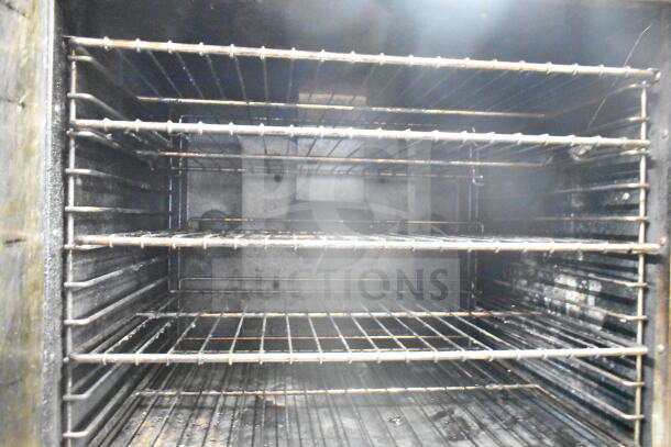 Royal commercial convection oven interior with multiple racks, view-through door, and visible wear.