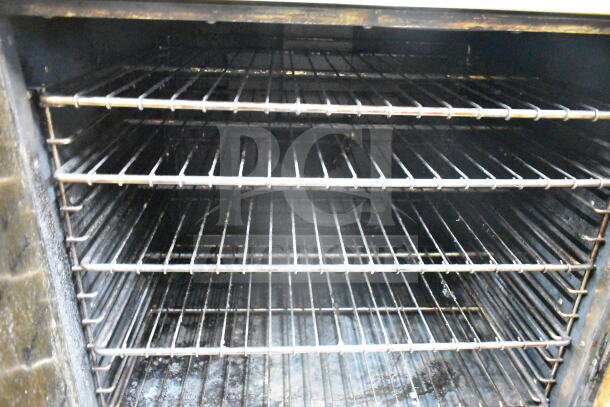 Royal commercial full-size convection oven interior, featuring multiple chrome racks, some signs of use visible.