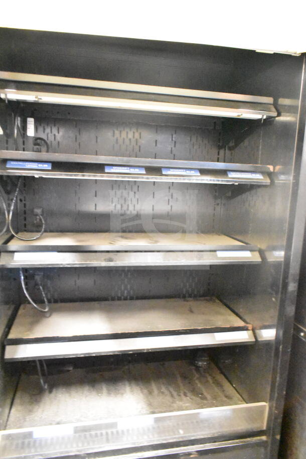 Structural Concepts Oasis B32EW merchandiser, 120V, 1 phase. Features open shelves, black finish. Shows signs of use.