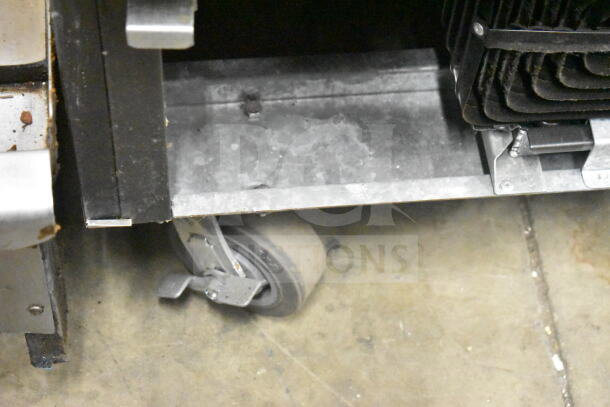 Beverage Air SR1HC-1S cooler caster detail, showing commercial-grade wheel on metal base; part of reach-in cooler.