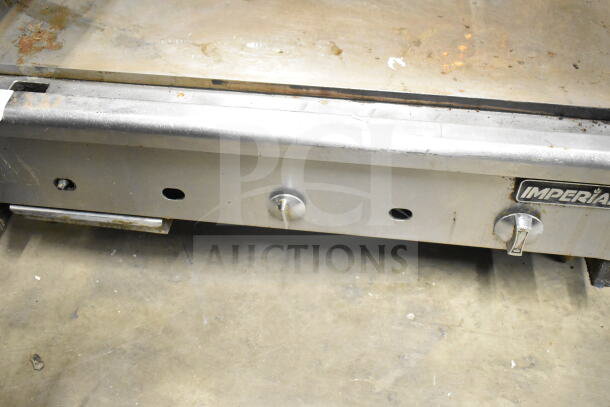 Imperial Commercial Gas Flat Top Griddle, stainless steel, visible wear, Imperial logo, control knobs present.
