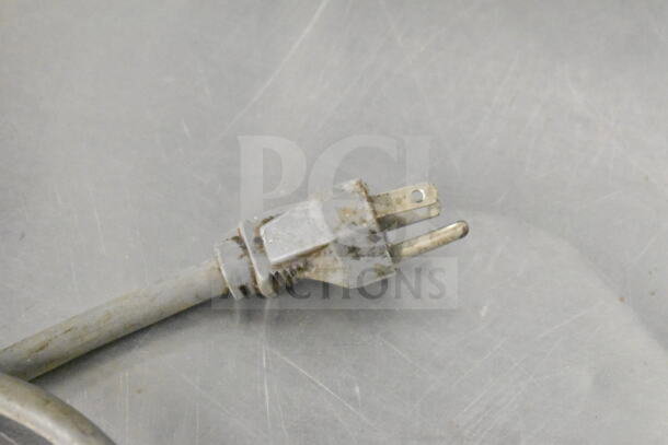 Frayed electrical plug of Master Bilt UC-48DR cooler, indicating wear and potential need for repair.