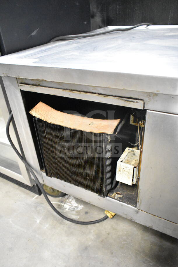 Traulsen Commercial 4 Drawer Chef Base, showing wear. 115 Volts, 1 Phase. Visible cooling system details.