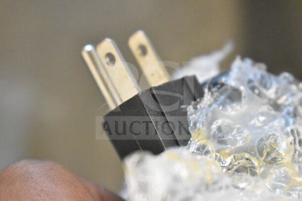 Close-up of a plug wrapped in bubble wrap for the 2023 Carnival King 382CM16A 16" Crepe Maker, 120V, 1 Phase.