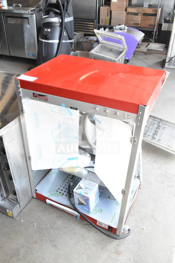 Brand new Paragon TP-16 popcorn machine, 16 oz, 120V, scratch and dent, Classic Pop model, red top, label visible.