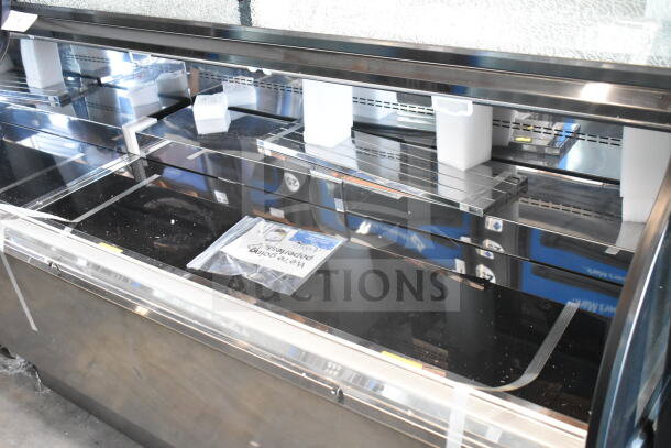 Avantco 193CAC60B 59 1/8" black curved refrigerated merchandiser. New, scratch and dent condition, broken glass visible. 115 Volts, 1 Phase.