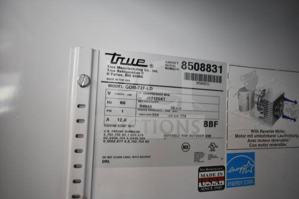 True GDM-72F-LD commercial freezer label showing model, voltage (115/208-240V), phase (1), refrigerant (R404A), and serial number.