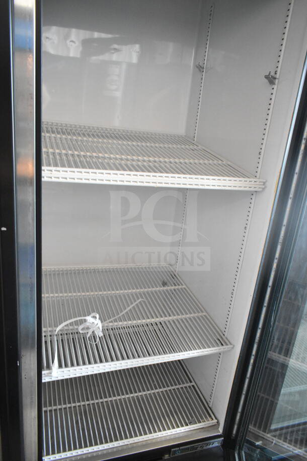 2016 True GDM-72-LD commercial 3-door cooler, 115V, 1 phase, white interior, metal shelves, used condition.