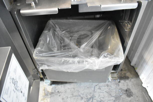 LATE MODEL JBT 2ND-GEN-MFJ Fresh N Squeeze citrus juicer on casters, floor style, 115V, shown with collection bin and liner.