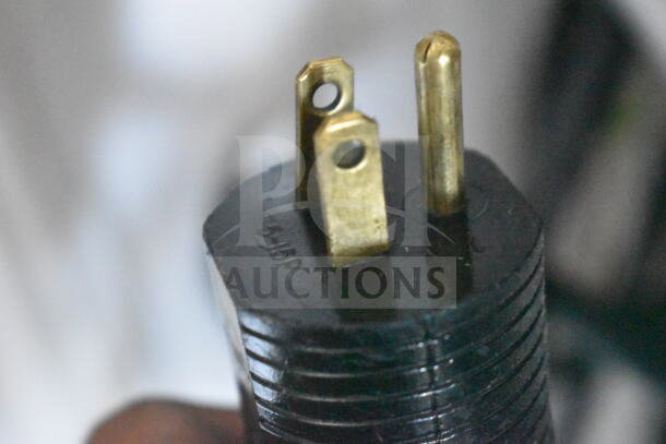 A black electrical plug with three prongs, showing the inscriptions "5-15P" on its surface.