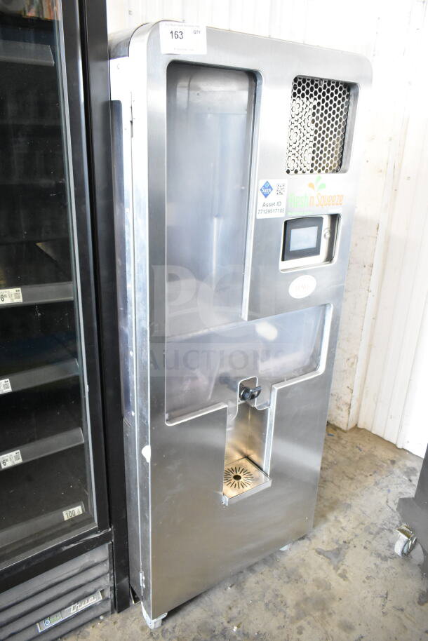 LATE MODEL JBT 2ND-GEN-MFJ-HE citrus juicer, commercial floor style on casters, 115V, Fresh N Squeeze label, asset ID visible.