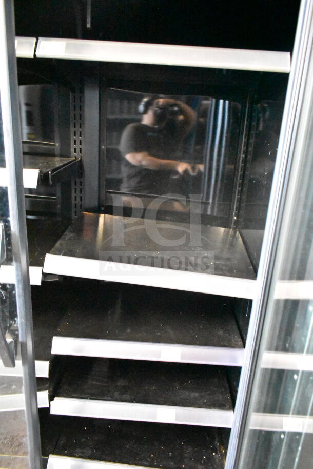 2021 True TVM-48SL-HC commercial 2-door cooler merchandiser with empty shelves, reflective interior. 115 volts, 1 phase.