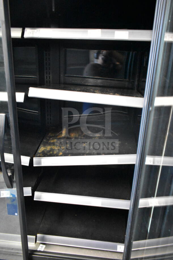 2021 True TVM-48SL-HC commercial cooler, 2 glass doors, visible shelving, 115 volts, 1 phase; shelves show wear.