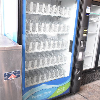 Crane 5800-4 vending machine, bill acceptor, glass front, shelves for bottled drinks, 115 volts, 1 phase.