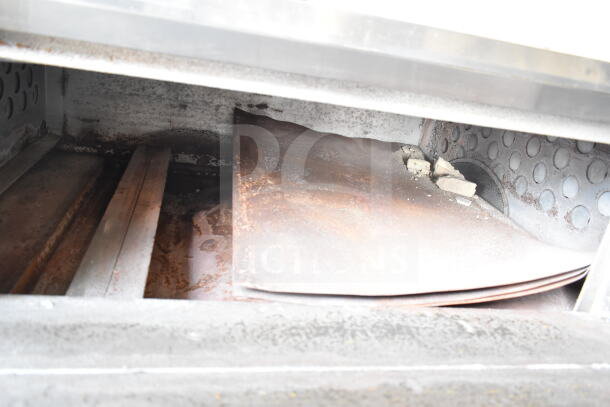 Bakers Pride D125 pizza oven interior showing wear; natural gas, single deck, 125,000 BTU, metal legs included.