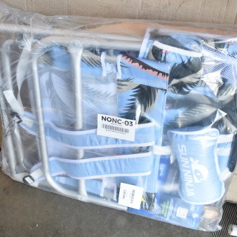 Foldable beach chair with blue palm design in packaging. Marked "SUN NINJA". New condition. Visible label "NONC-03".
