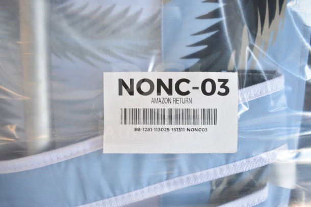 Blue beach chair, new condition, wrapped in plastic. Label reads "NONC-03 Amazon Return," includes barcode SB-1281-113025.
