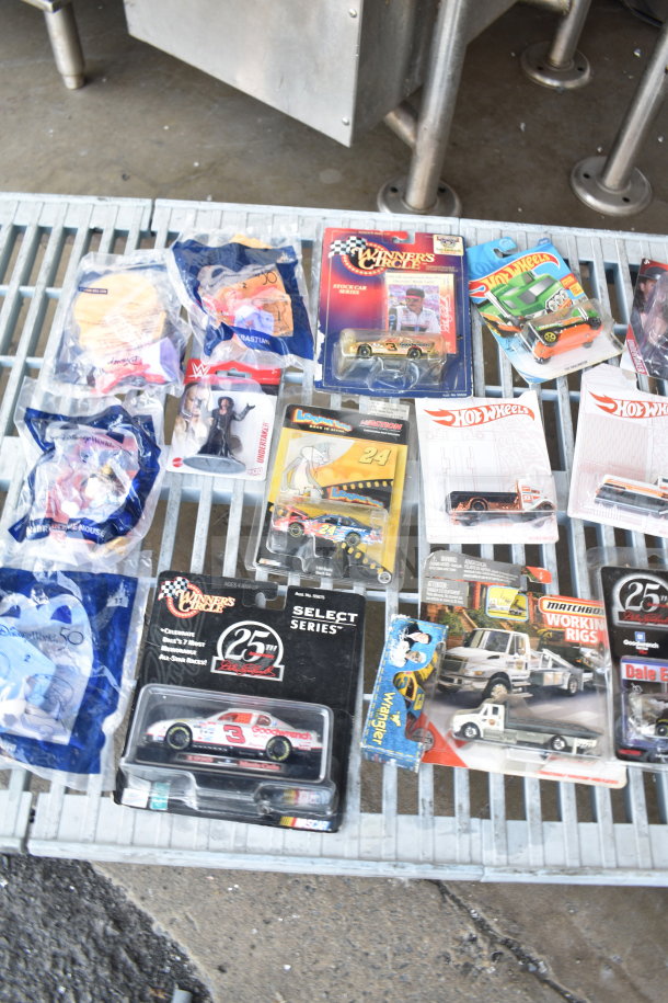 16 various collectible items including die-cast cats and Hot Wheels cars, mixed packaging, varying conditions.
