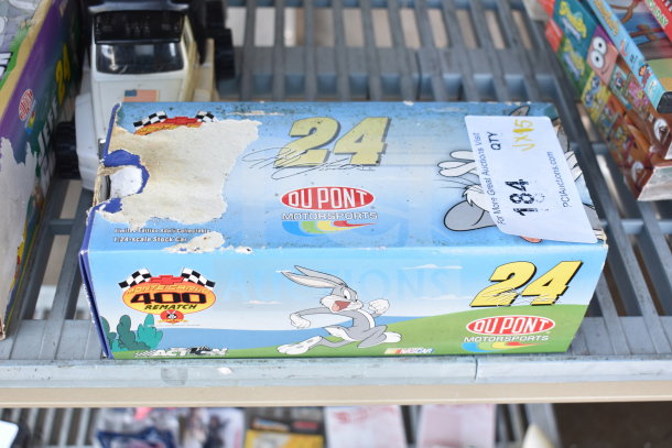 DuPont 24 Stock Car 1:24-scale box, limited edition, with Bugs Bunny design; worn packaging on shelf.