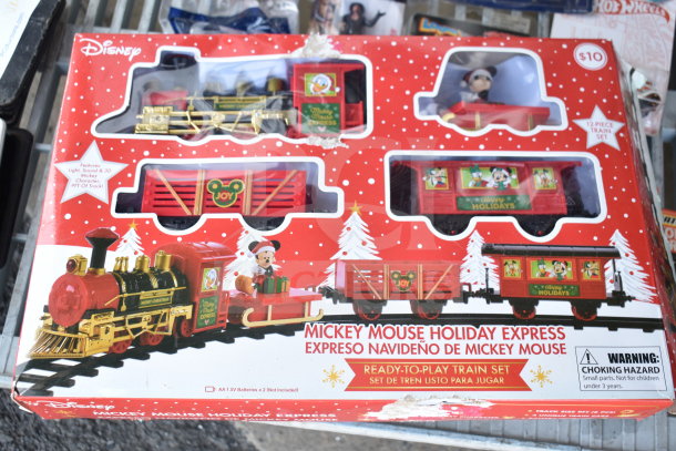 Mickey Mouse Holiday Express Train Set, new, features lights and sounds, includes 12 pieces with 9 ft of track, boxed.