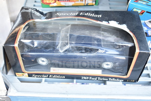 Boxed Maisto Special Edition 1969 Ford Torino Talladega 1:18 model car, slightly worn packaging, visible branding and warning label.