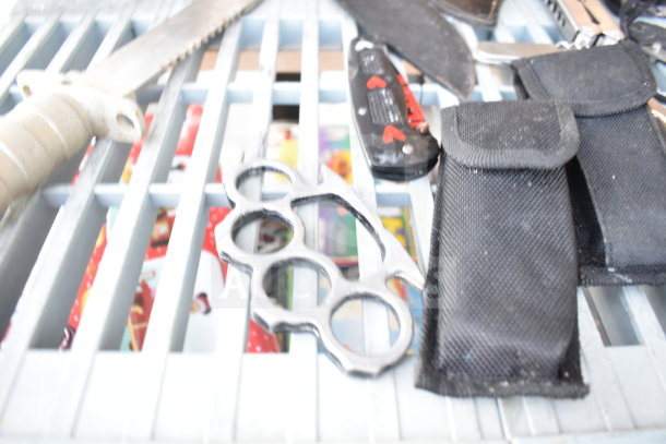 13 various items including survival knives, brass knuckles, drill bits, and black pouches. Mixed condition.