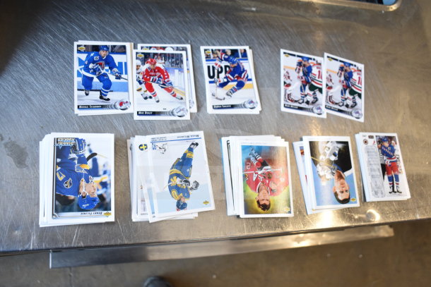 Lot of assorted ice hockey trading cards, featuring players in action. Cards vary in condition. Includes multiple stacks with visible player names.