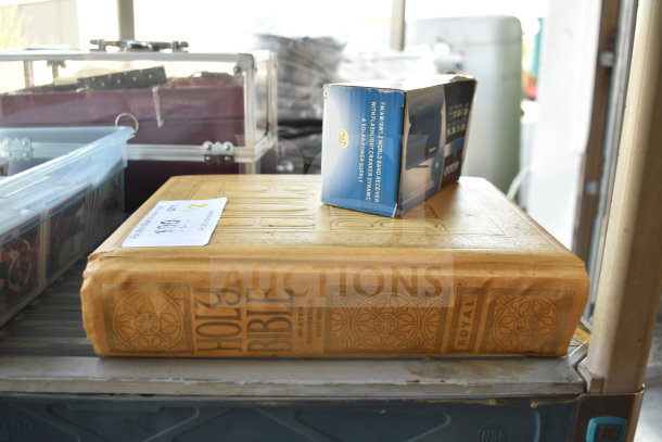 Holy Bible Master Reference Edition with embossed cover, alongside Kozo FM/AM World Band Receiver in box. Auction label shows lot info.