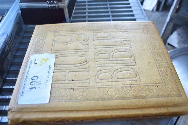 Antique Holy Bible with embossed cover; includes auction tag indicating quantity and bid instructions.