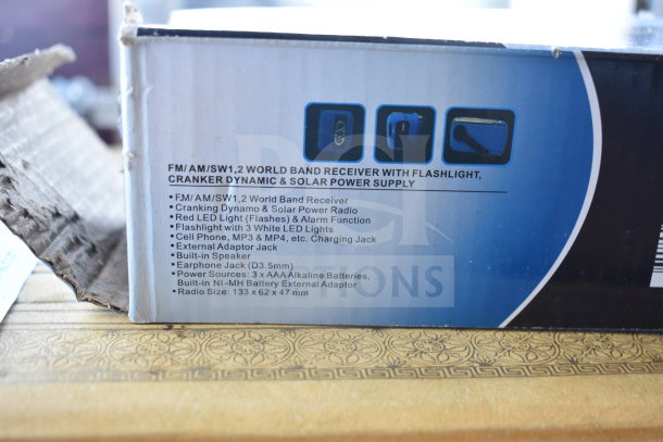 Two items: Holy Bible and Kozo FM/AM World Band Receiver. Receiver features cranking, solar power, LED light, earphone jack. Box shows specifications.