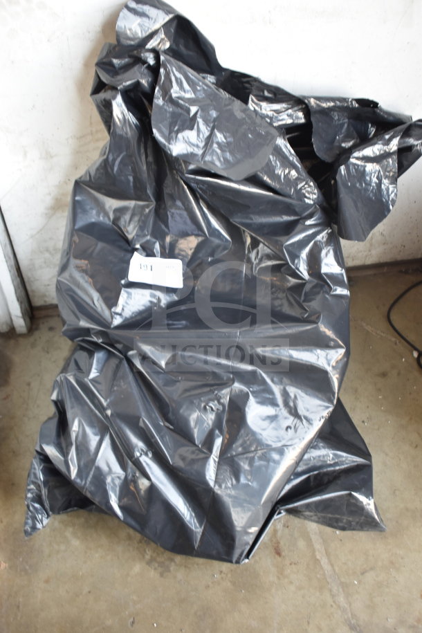 Black garbage bag containing multiple items, labeled as lot 191. Contents unclear, described as turtle stuffed animal, play horse, and elf.