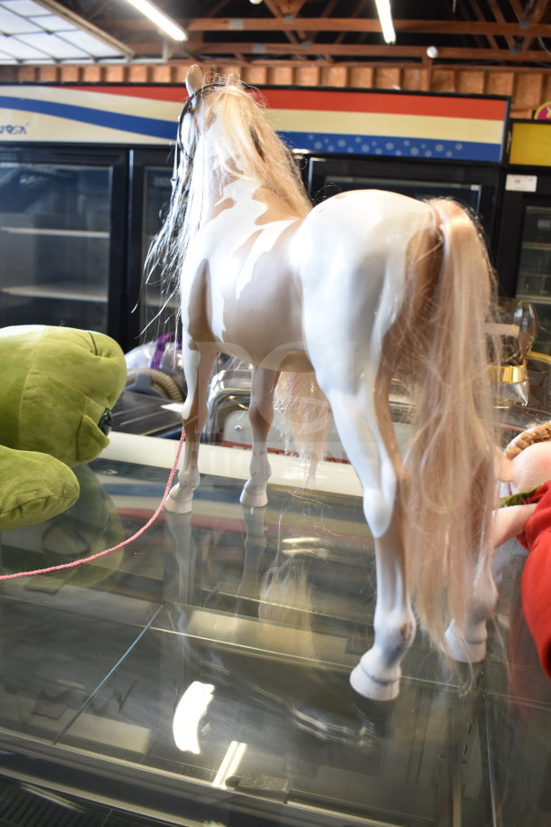 Lot of toys including a green turtle stuffed animal and a plastic play horse with blonde mane. Excellent condition.