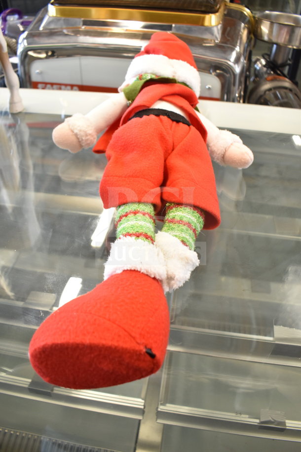 Elf stuffed toy in red and green attire on display, part of a toy lot including a turtle stuffed animal and play horse.