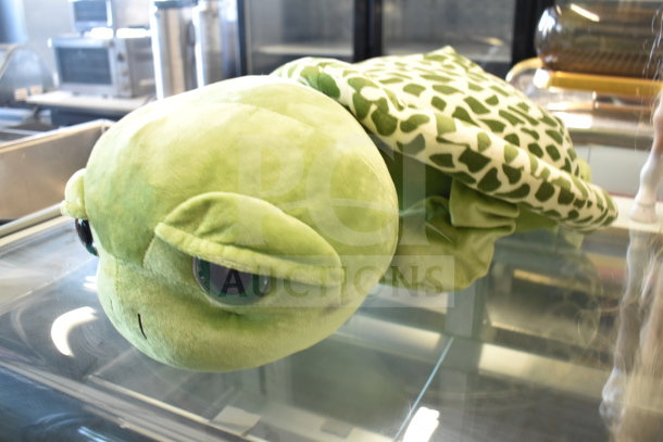 Turtle stuffed animal with green shell pattern, plush material, well-maintained; part of an auction lot with a play horse and elf.